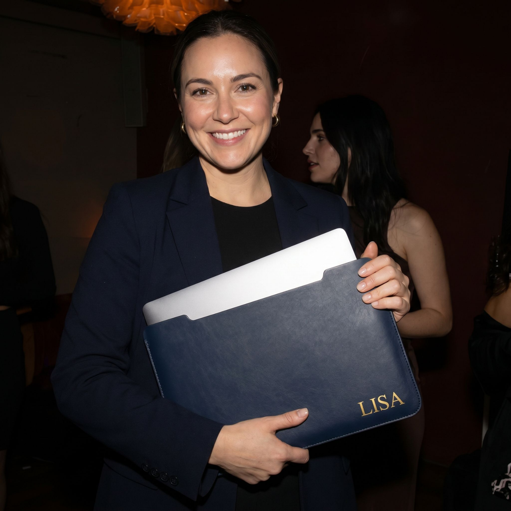 Happy attendee with personalised leather laptop sleeve